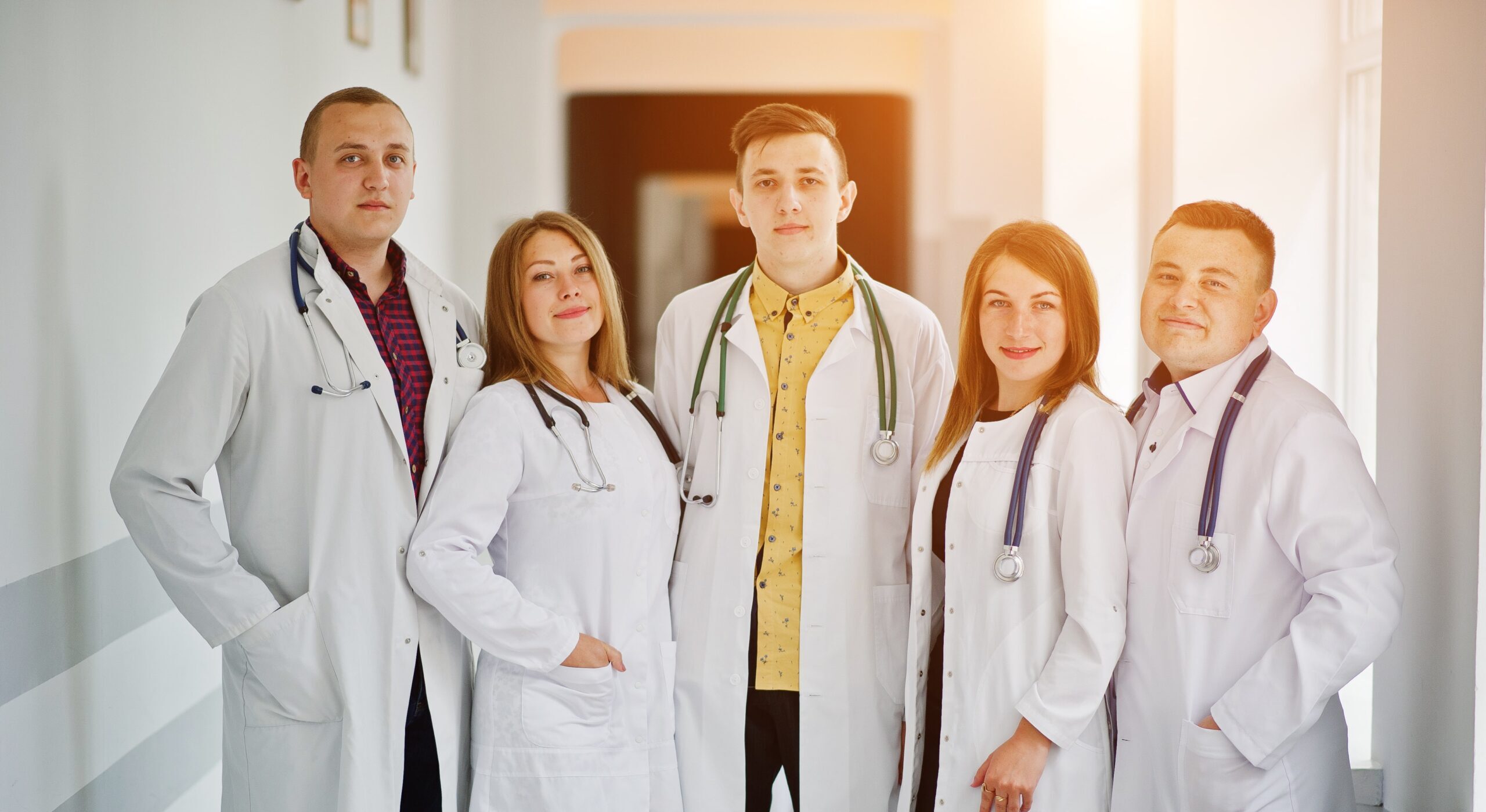 group young doctors white coats posing hospital min scaled e1731671216783