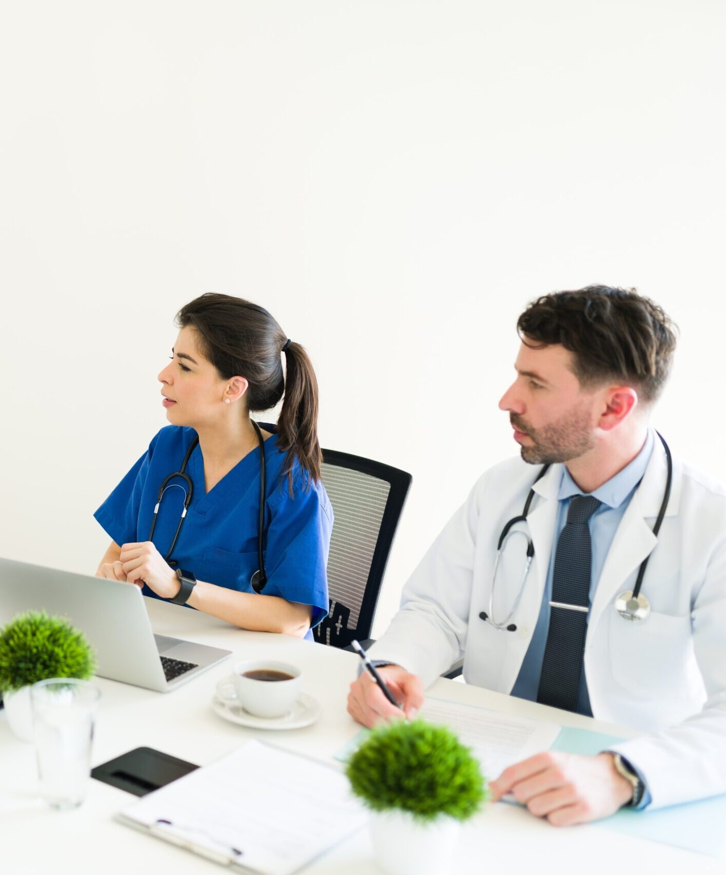 handsome hospital director talking medical board meeting room specialist checking medical case with latin doctor caucasian nurse min scaled e1730763763209