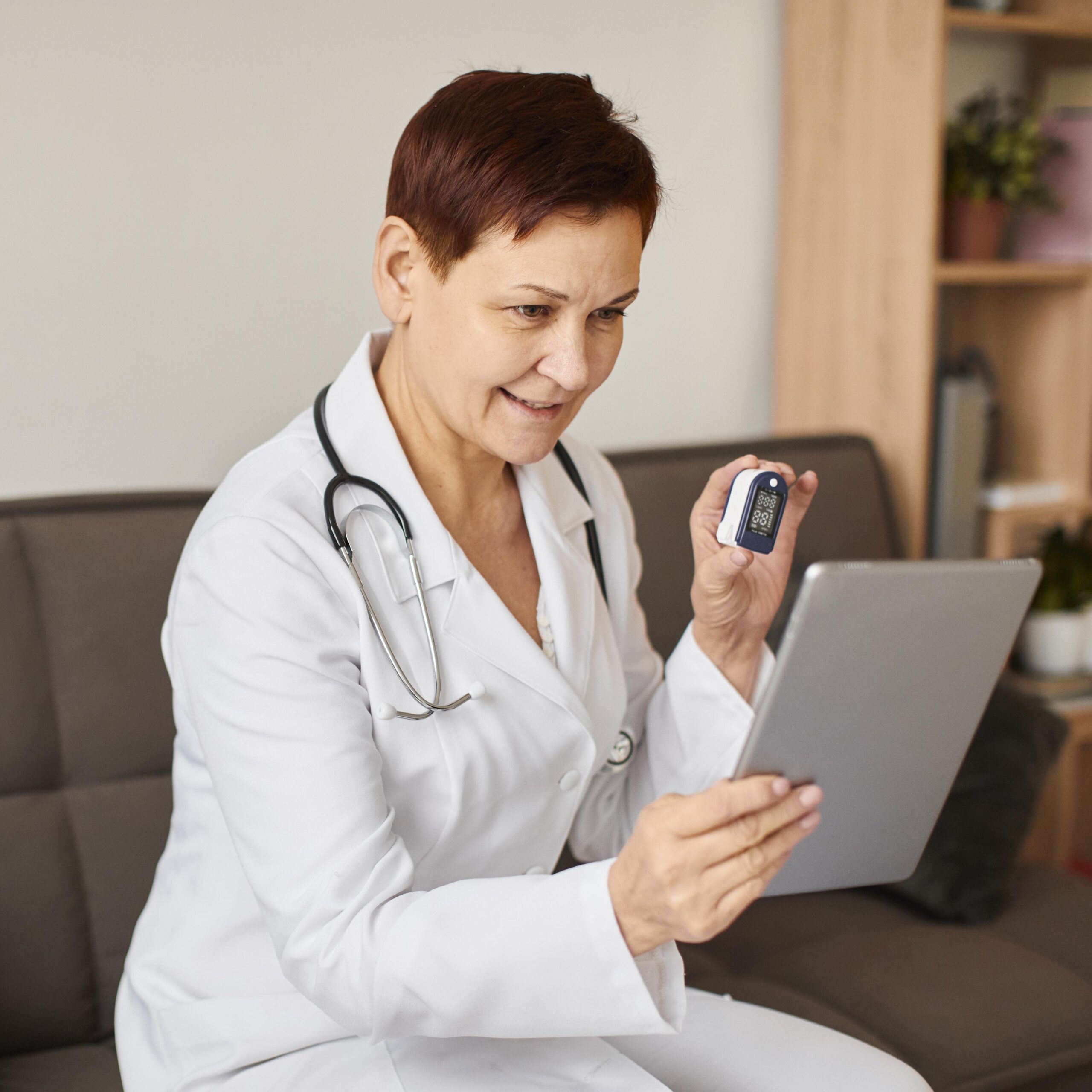 smiley elder covid recovery center female doctor with tablet oximeter min scaled