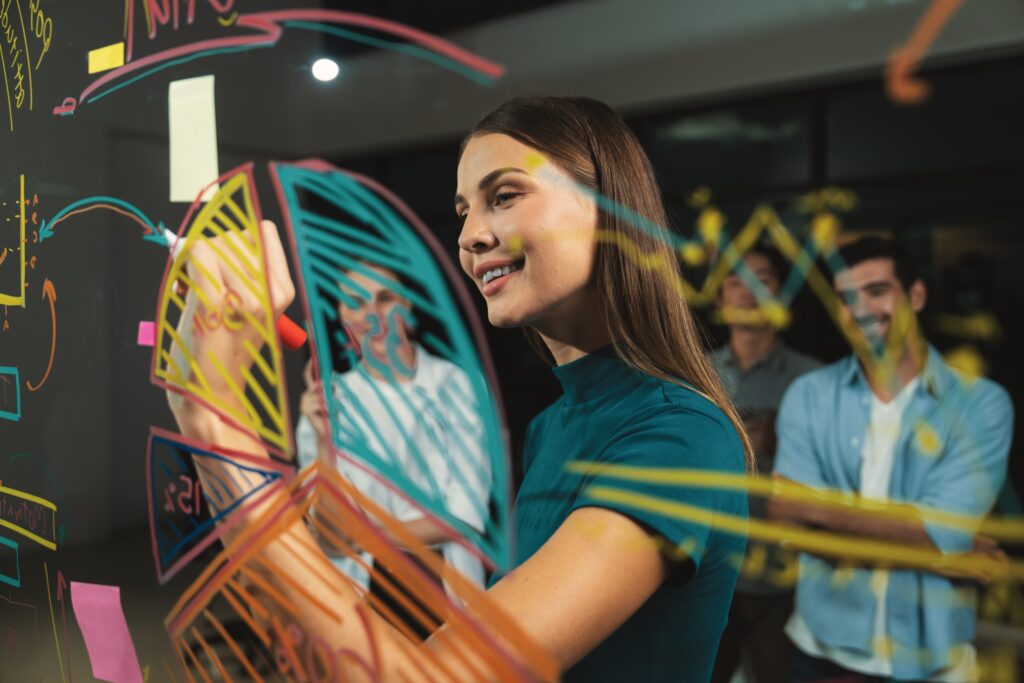 young beautiful businesswoman writing business plan investor glass wall skilled female leader presenting marketing strategy by using graph smart manager presenting marketing idea tracery