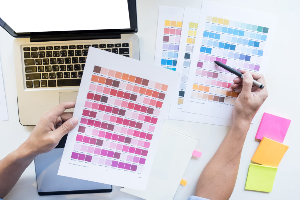vista superior de un joven disenador grafico que trabaja en una computadora de escritorio y el uso de algunas muestras de color vista superior