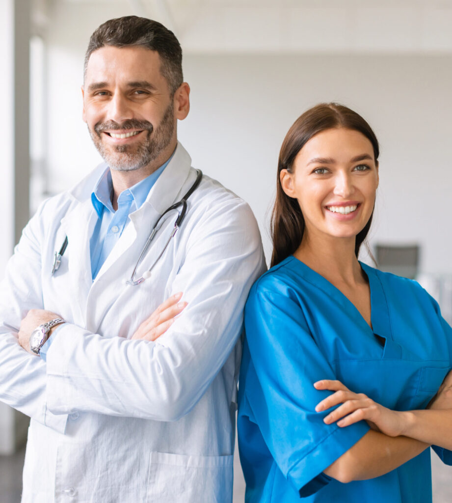 confident caucasian colleagues male doctor female nurse wearing coats posing with folded arms scaled e1787190289981